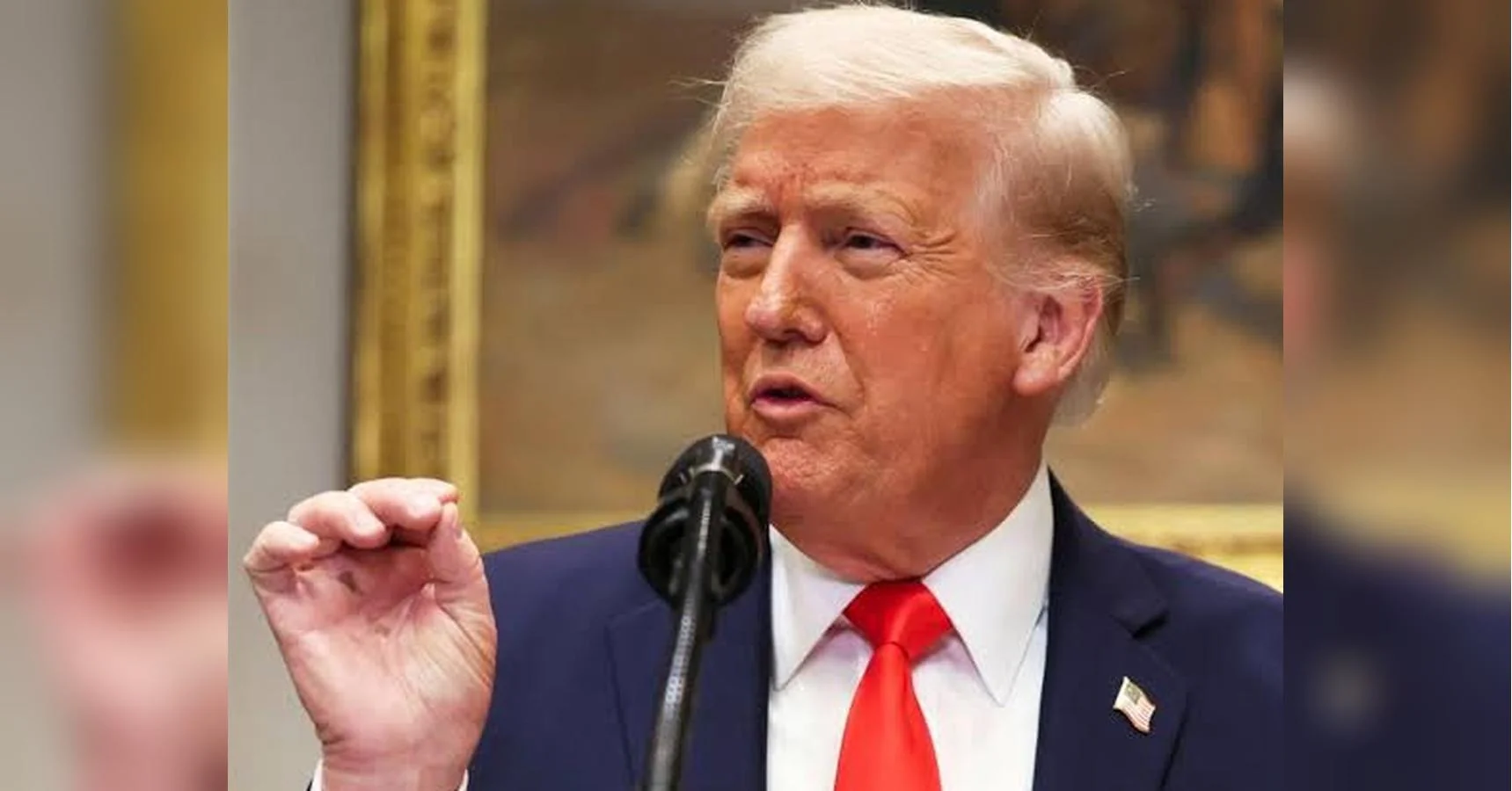 Дональд Трамп говорить у мікрофон і жестикулює рукою на церемонії